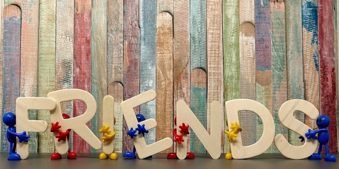 Friends Figures Holding Letters